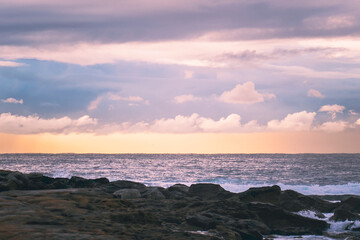 Sunrise over rocks at beach, landscape, room for copy, room for text, background landscape image