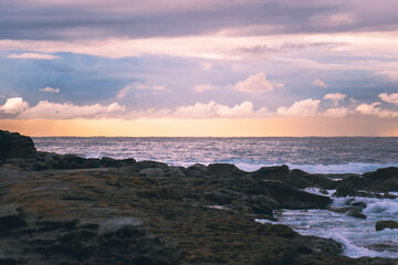 Sunrise over rocks at beach, landscape, room for copy, room for text, background landscape image