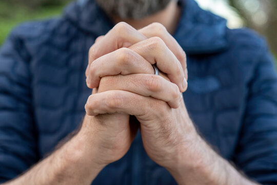 Praying hands of young man.
