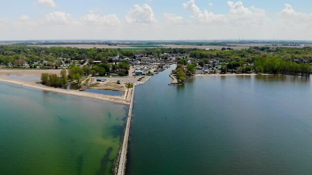 Aerial footage over Lake Huron approaching small rural town of Caseville, Michigan