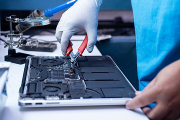 engineer repairs the laptop and the motherboard.