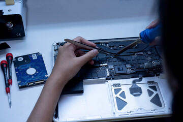 engineer repairs the laptop and the motherboard.