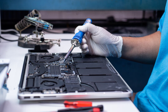 engineer repairs the laptop and the motherboard.