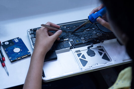 engineer repairs the laptop and the motherboard.