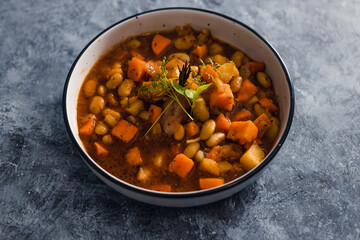 plant-based food, vegan sweet potato and pumpkin stew with butter beans and roasted veggies