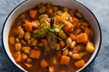 plant-based food, vegan sweet potato and pumpkin stew with butter beans and roasted veggies