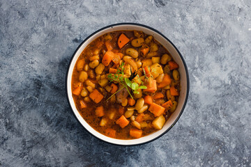 plant-based food, vegan sweet potato and pumpkin stew with butter beans and roasted veggies