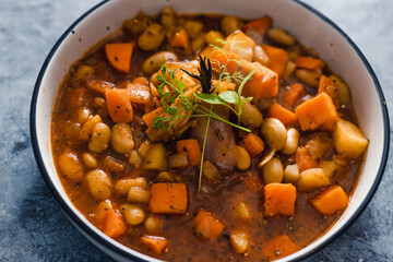 plant-based food, vegan sweet potato and pumpkin stew with butter beans and roasted veggies