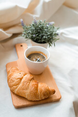 croissant with coffee put on cutting boards