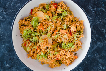 plant-based food, vegan ginger noodles with stir fry vegetables and grated celeri