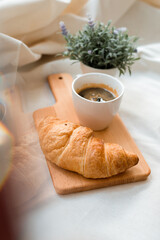 croissant with coffee put on cutting boards