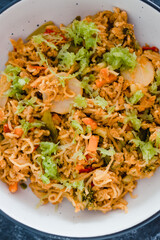 plant-based food, vegan ginger noodles with stir fry vegetables and grated celeri