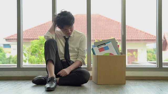 The dismissed company employee was sad. He subsided, wanting to be exhausted by the glass wall.
