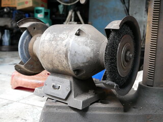 electric bench grinder in a garage.