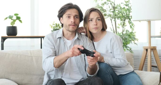 Crazy couple playing video game at home during weekend