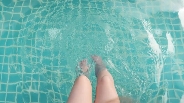 Top view of legs woman in the water pool, Splashing water, Slow motion,4K
