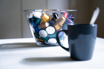 Coffee capsules or pods of italian espresso of different colors on a white background 