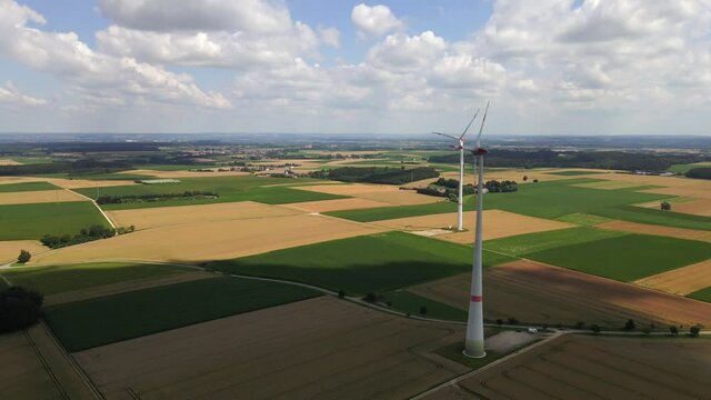 Drone shot circling an electric Windmill counter clocwise