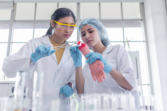 asian woman's students nurse intern medical cleaning wound with cotton with arm model in hospital. learning for work future.