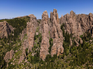 needles spires off needles highway in black hills of South Dakota in the morning sunlight with bright blue sky in the background and pine trees