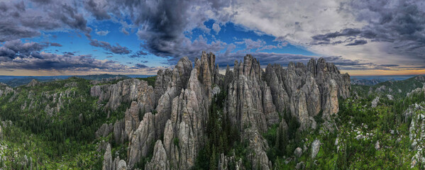 panorama of needles spires with storm clouds in the background off needles highway in black hills...