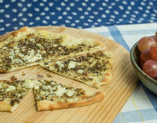Hot from the oven flatbread with Za'atar herbs and feta cheese as topping.  