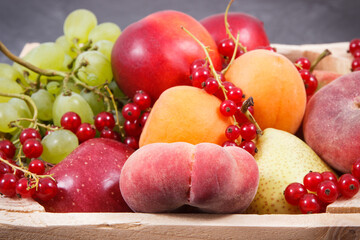 Fresh ripe fruits in wooden box. Food containing healthy minerals and vitamins