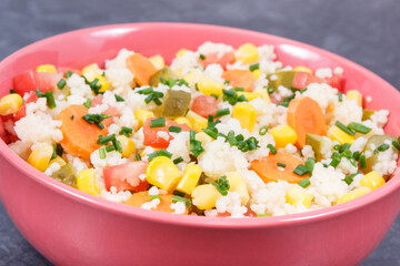 Salad with vegetables and couscous groats. Light and healthy meal containing vitamins and minerals