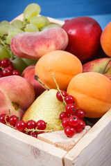 Heap of fresh ripe fruits in wooden box. Food containing healthy minerals and vitamins