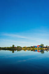 Obraz premium Small village, houses reflection in the lake Seliger