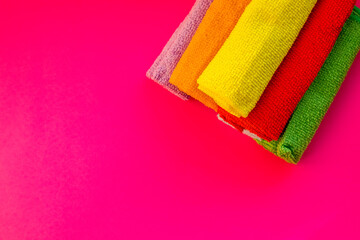 Close-up of five overlapping microfiber cleaning clothes of different colors. Top view. Cleaning service,tools. microfiber towels.Copy space