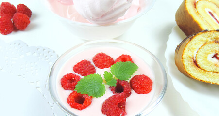 sweet desserts yoghurt with fresh raspberries and mint, marshmallows and tender biscuit with cream, selective focus