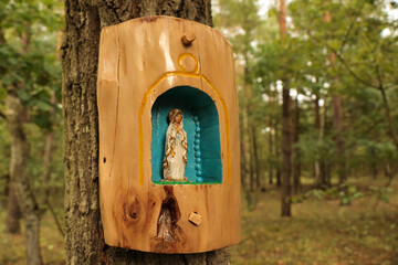 A wooden chapel on a tree in the forest
