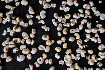 A lot of fallen popcorn on a black background