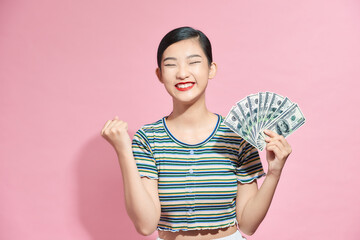 Woman young adult happy and enthusiastic with a fan of money in the Studio