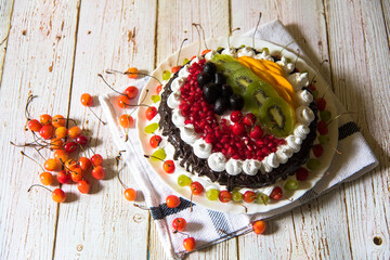 Delicious fruit cake and scattered cherries with use of selective focus