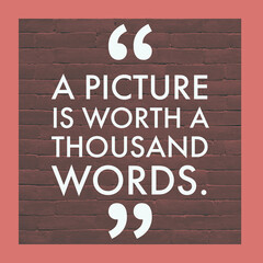 A picture is worth a thousand words, 
English Motivational Quote with border and bricks at the...