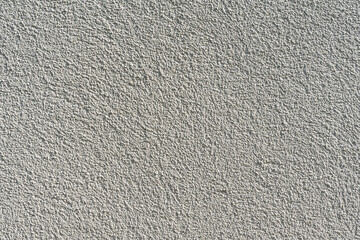 texture of an uneven painted beige rough wall