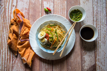 Noodles and condiments on a background