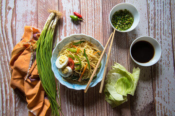 Noodles, a Chinese recipe with condiments and ingredients with use of selective focus 