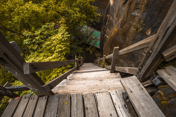 Fototapeta premium Background of wooden walkways (wooden bridges) created for high-angle views on mountains, natural attractions, or parks that have forest preservation