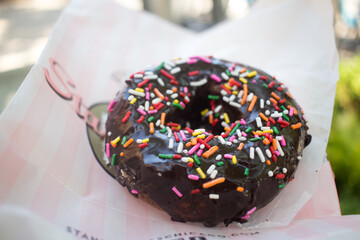 chocolate iced cake donuts with colored sprinkles