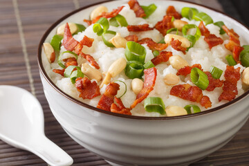 Ginger bacon Jook Rice Porridge close-up in a bowl on the table. horizontal