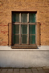 Fototapeta na wymiar old barred window on a brick wall
