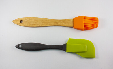 Silicone brush and Rubber spatula on white background