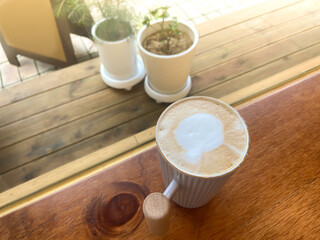 Cappuccino in a white mug on a cafe table, vintage feel