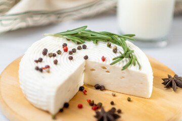 Homemade Adyghe cheese on a plate with spices