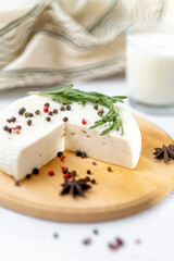 Homemade Adyghe cheese on a plate with spices