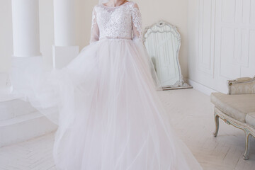 Fototapeta premium bride in a wedding dress in a bright room