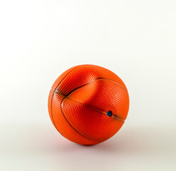 Crushed toy basketball ball, isolated. Copy space for text.